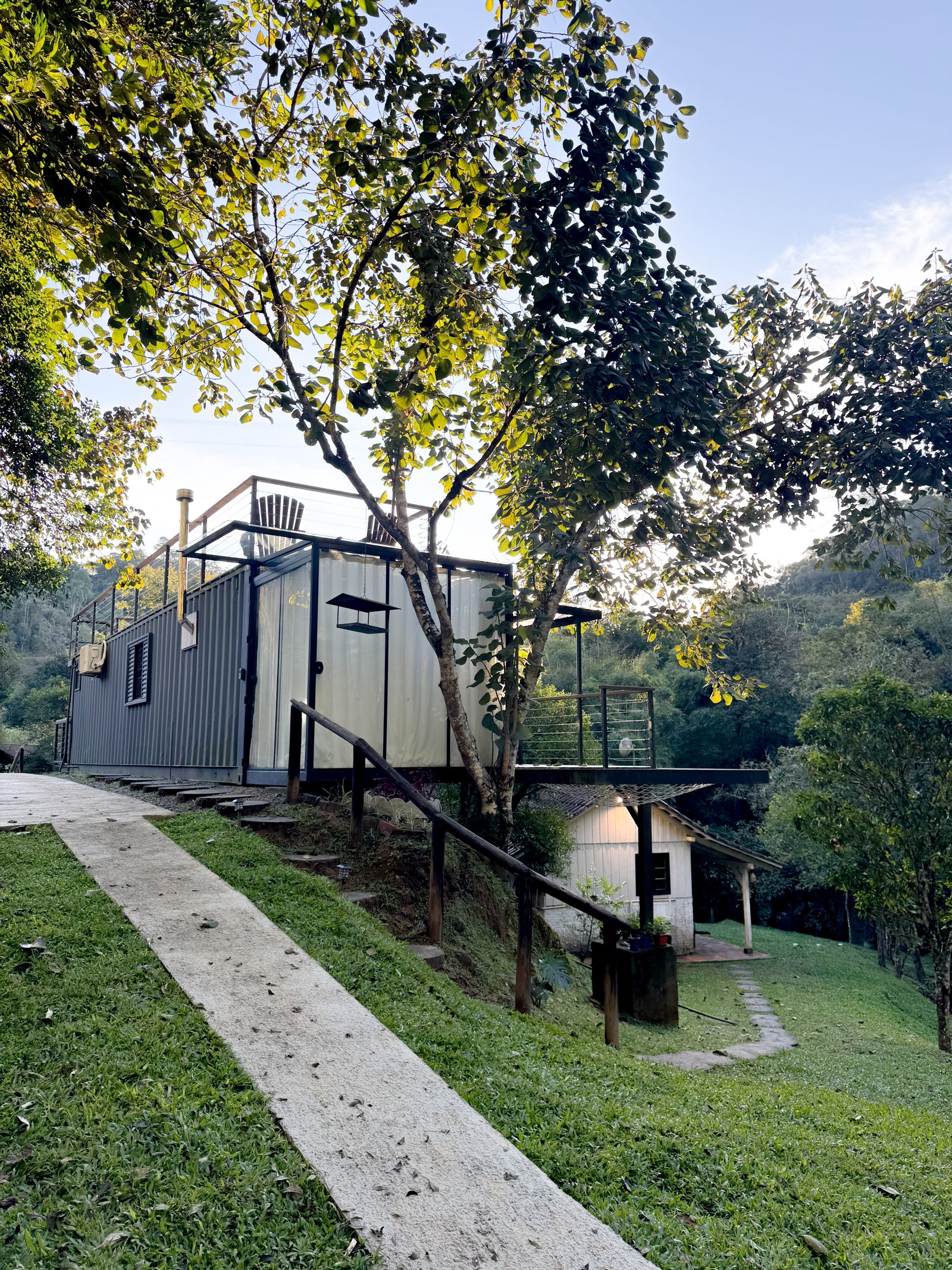Modern custom container building with windows and a covered deck